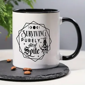 Ceramic coffee mug detailed view, black and white design with bat graphic, perfect for office use.