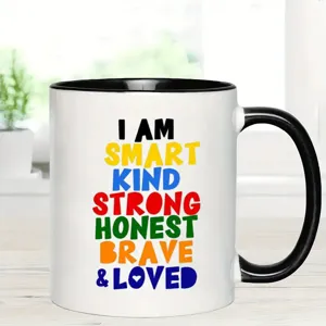 White ceramic coffee mug featuring inspirational text, black handle and rim, perfect office cup.