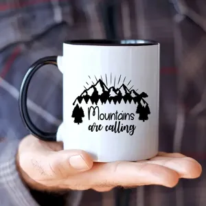 Ceramic coffee mug detail, black handle and rim, mountain pattern, office and home use cup