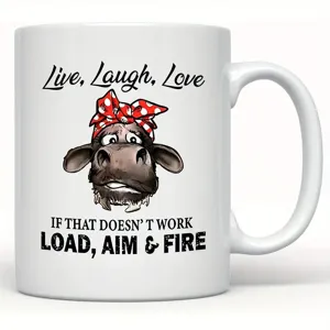 Detail view of a white ceramic coffee mug featuring a cute cartoon cow and funny quote text.