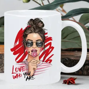 Close-up detail of a white ceramic coffee mug featuring stylish fashion illustration art.