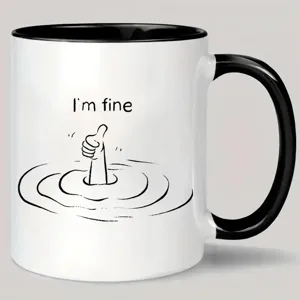 Vista detallada de la taza de café de cerámica bicolor con estampado divertido y asa negra.