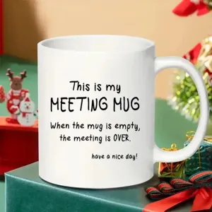 Detailed view of white ceramic coffee mug with funny printed text, perfect desk gift.