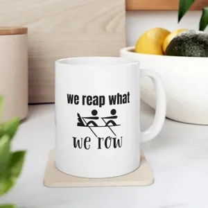 White ceramic coffee mug with custom rowing quote print, clean kitchen background detail.