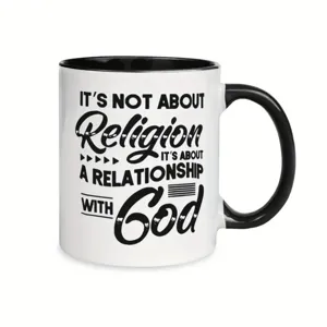 Detail view of white ceramic coffee mug with black handle and inspirational religious quote print.