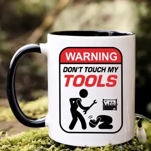 Ceramic coffee mug detail view, black handle and rim, funny warning tool design, office cup.