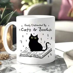 Detailed view of white ceramic coffee mug with cute cat and book illustration and quote.