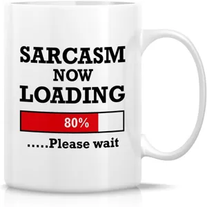 Ceramic coffee mug detail showing funny sarcasm loading text design on white cup surface.