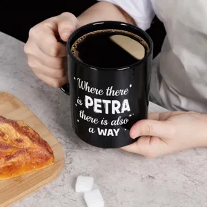 Black ceramic coffee mug with German text print, ideal for office and daily home use.