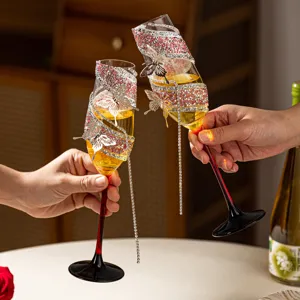 Crystal champagne flutes pair with sparkling rhinestones and metal butterflies for wedding toast.