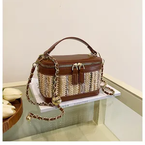 Chic woven box handbag with top handle and gold chain strap, stylish summer travel purse.