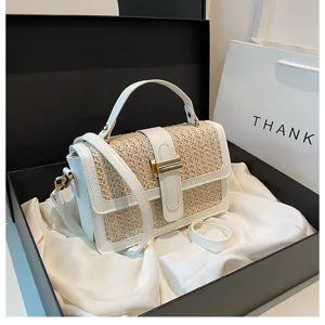 Chic white straw woven flap crossbody bag detail, elegant top handle and metal lock closure.