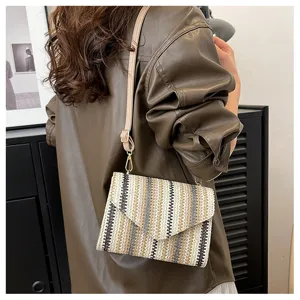 Stylish straw crossbody bag for women with colorful stripes, perfect for summer beach and daily use.