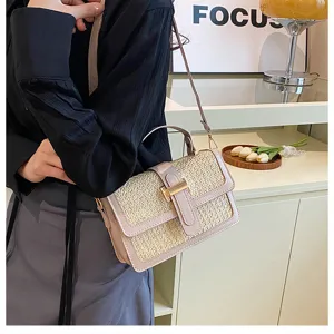 Detailed shot of stylish woven straw flap crossbody bag with leather trim and metal lock.