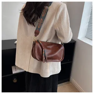 Brown soft leather shoulder crossbody pillow bag with ethnic wide strap for casual daily use