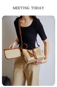 Woven straw shoulder bucket bag with contrast leather trim, stylish summer handbag for women.