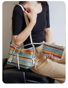 Detailed view of stylish colorful woven underarm shoulder bag featuring a matching pouch.