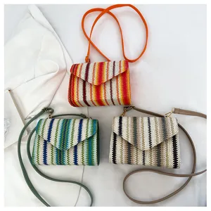 Detailed view of woven crossbody bags with colorful stripes, stylish beach shoulder bags.
