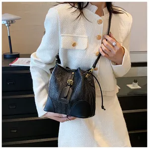 Black woven bucket bag with drawstring closure and shoulder strap, stylish and casual design.