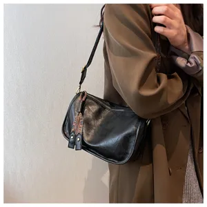 Black soft leather shoulder bag for women, casual crossbody pillow bag with ethnic strap.