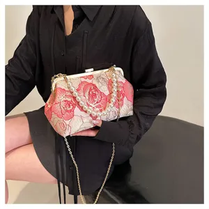 Exquisite Chinese style floral embroidered handbag with elegant pearl chain and strap detail.