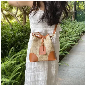 Summer straw bucket bag for women, stylish woven shoulder bag with PU leather trim.