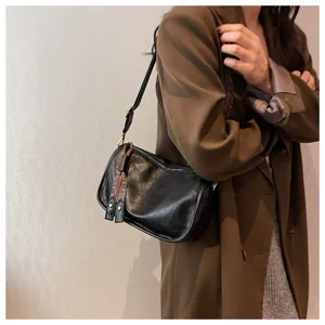 Stylish black soft leather shoulder bag, casual crossbody pillow bag with unique strap design.
