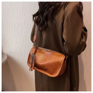 Detailed shot of soft leather casual pillow bag, large capacity stylish crossbody shoulder bag.