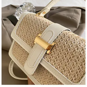 Woven straw crossbody bag with white PU leather trim and chic metal clasp for women vacation.