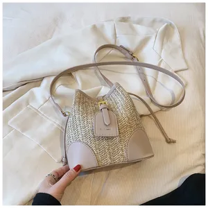 Woven straw bucket bag with PU leather trim, stylish single shoulder bag for summer daily wear.