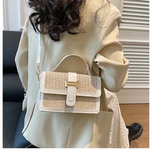 Woven straw crossbody bag for women, stylish flap handbag with top handle and strap.