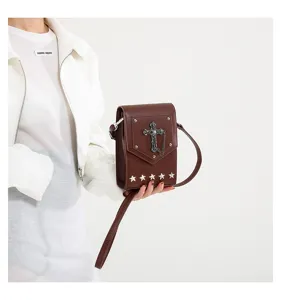 Retro brown leather cross-body mini bag with gothic cross and star studs for women.
