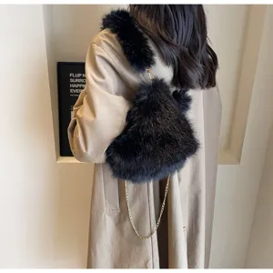 Black plush faux fur shoulder bag detail, stylish chain strap, cozy autumn fashion accessory.