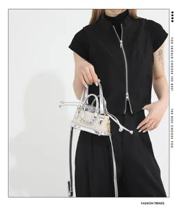 Mini straw woven handbag with silver metallic leather trim, trendy shoulder crossbody bag for women.