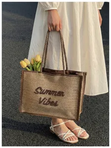 Detailed close-up of a woven straw beach tote bag featuring Summer Vibes embroidery for vacation style.