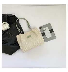 Summer woven straw shoulder tote bag with green leather strap, stylish beach vacation handbag.