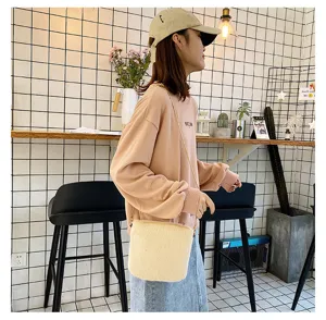 Detailed side view of the cute candy-colored plush bucket bag with chain strap in autumn.