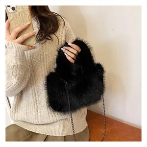Black fluffy plush shoulder bag with metal chain strap, trendy winter furry handbag.