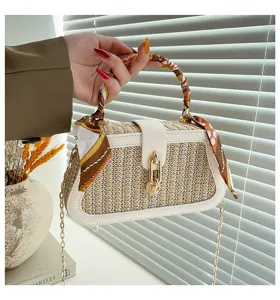 Straw woven shoulder bag with white trim and silk scarf handle for women daily fashion use.