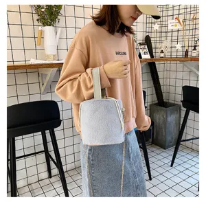 Fluffy winter plush bucket bag with drawstring and elegant chain strap, soft fuzzy handbag.