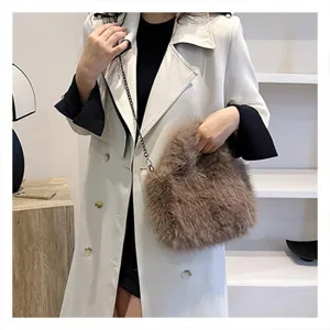 Detailed view of brown faux fur crossbody bag with chain strap, stylish winter accessory.