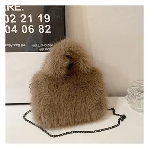 Detailed view of stylish fluffy brown plush shoulder bag featuring dark metal chain strap.