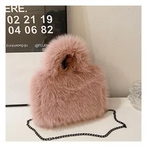 Detailed shot of pink fluffy plush faux fur handbag with black chain strap and soft texture.