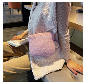 Cozy autumn winter plush crossbody bag in candy purple color with chic chain strap detail.
