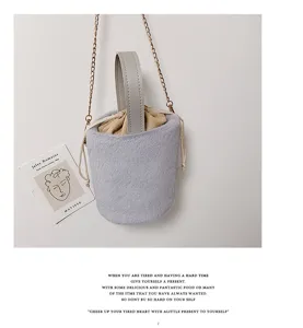 Autumn winter fluffy bucket shoulder bag soft plush handbag with chain and drawstring design.