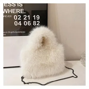 Detailed view of white fluffy plush shoulder bag with metal chain strap for autumn style.