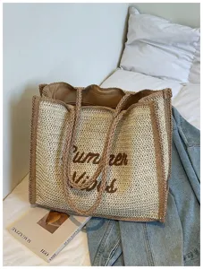 Large capacity straw woven tote bag detail shot, stylish casual beach vacation handbag.