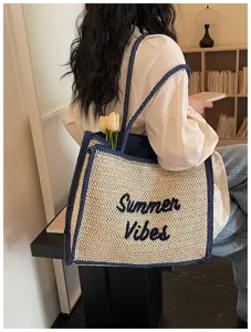 Woven straw tote bag for women, casual summer beach shoulder bag with stylish lettering.