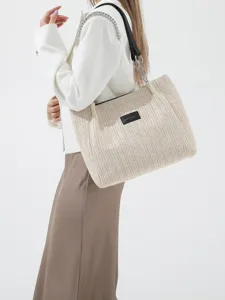 Stylish woven straw shoulder tote bag for women, perfect for summer beach vacations.