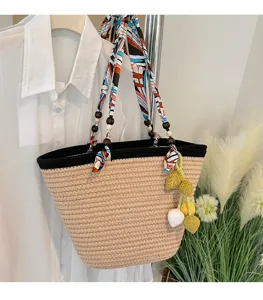 Woven straw tote bag with colorful silk scarf handle, wooden beads, and crochet fruit charm.